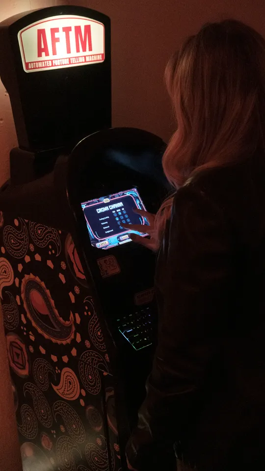 AFTM Automated Fortune Telling Machine at Bu Tea Den, lit by red lanterns