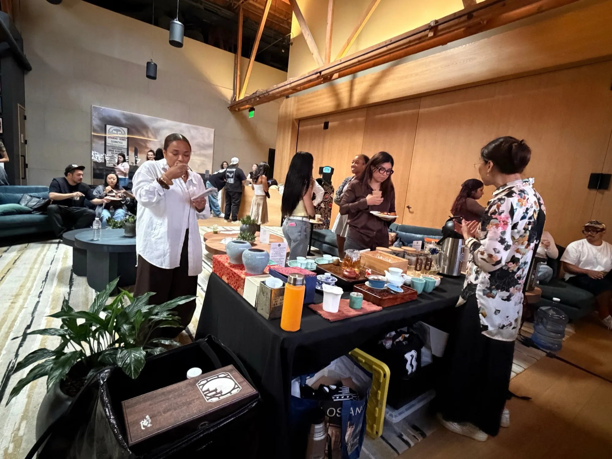 Our tea bar and an AFTM at a corporate event, guests around them
